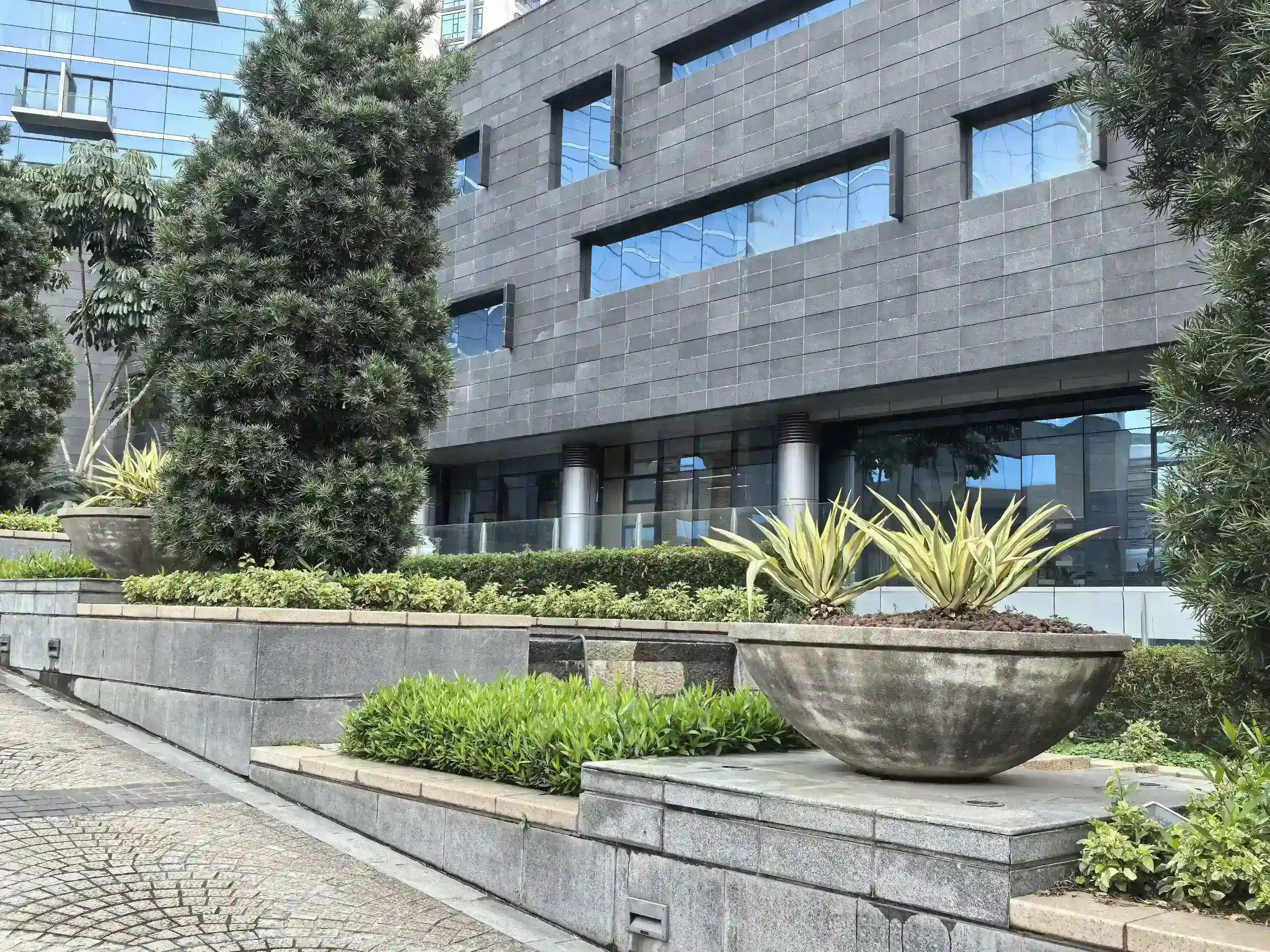 Oversized GRC bowl planters supplied for a completed hospitality landscape project
